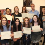 students holding certificates intern art show